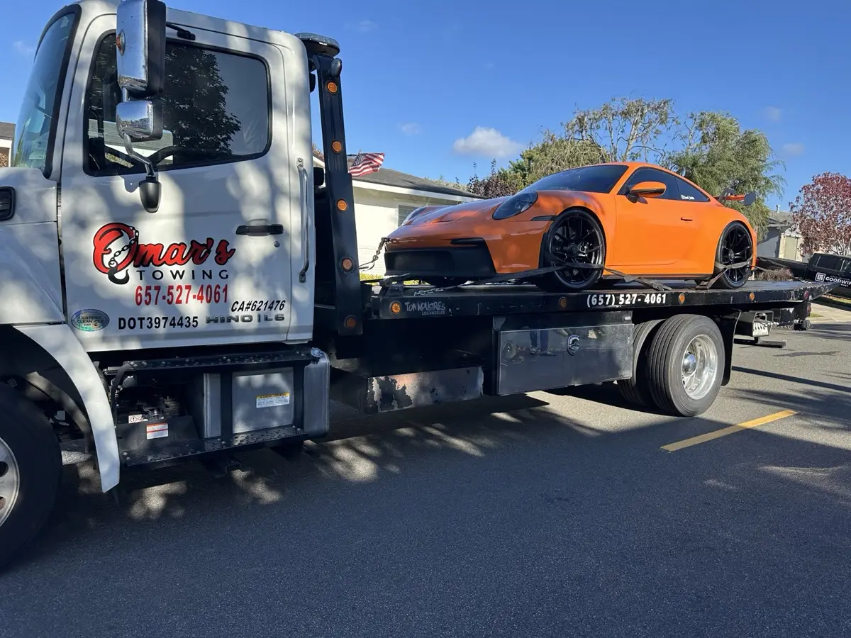 Low-clearance Porsche 911 GT3 loaded on a flatbed